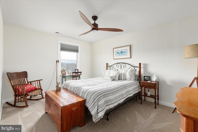 carpeted bedroom with baseboards, visible vents, and a ceiling fan