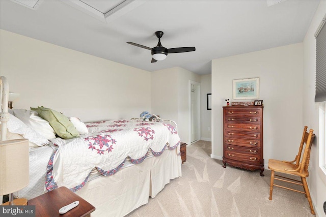 bedroom with ceiling fan, baseboards, and light colored carpet