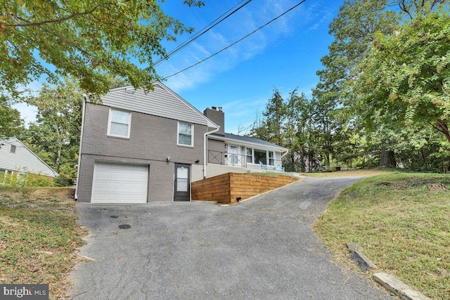 view of front of home featuring a garage and a front lawn