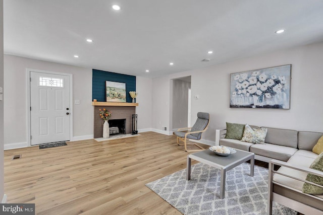 living room featuring a fireplace and light hardwood / wood-style flooring