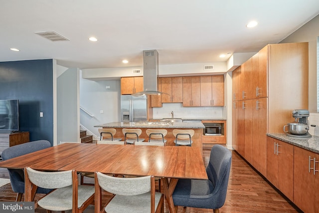 dining area with hardwood / wood-style flooring and sink