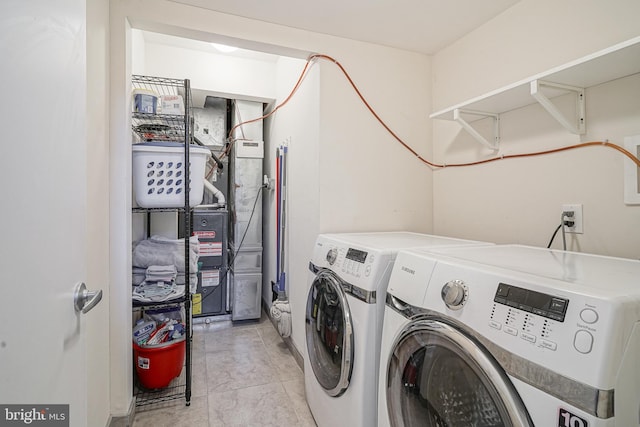 laundry room with light tile patterned flooring and washer and dryer