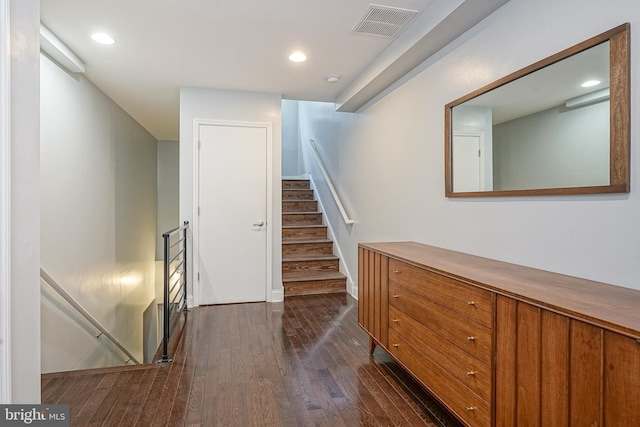 stairway with hardwood / wood-style floors