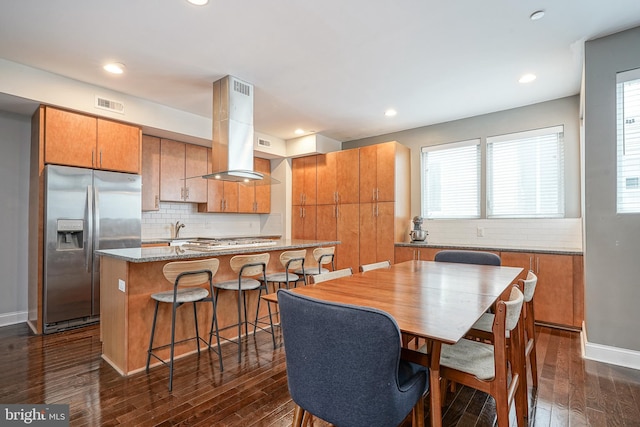 dining space with dark wood-type flooring and sink