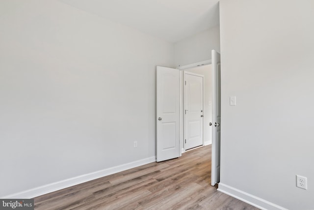 empty room with light hardwood / wood-style flooring