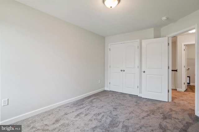 unfurnished bedroom featuring a closet and carpet flooring