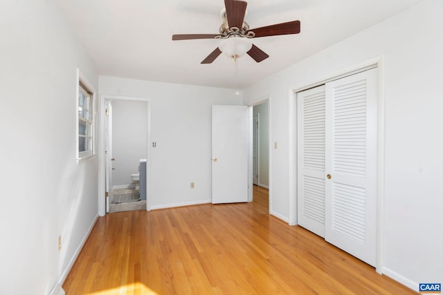 unfurnished bedroom featuring a closet, ensuite bathroom, ceiling fan, and light hardwood / wood-style flooring