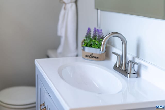 interior space with vanity and toilet