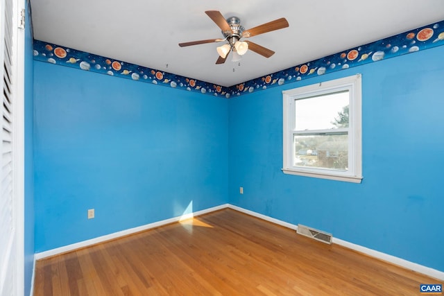 empty room featuring wood-type flooring and ceiling fan