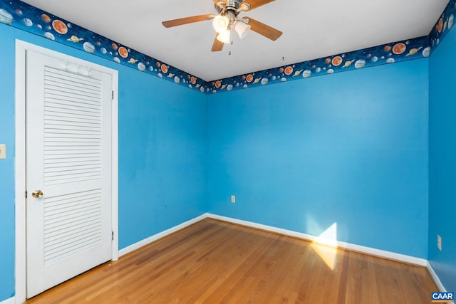 unfurnished room featuring ceiling fan and hardwood / wood-style floors