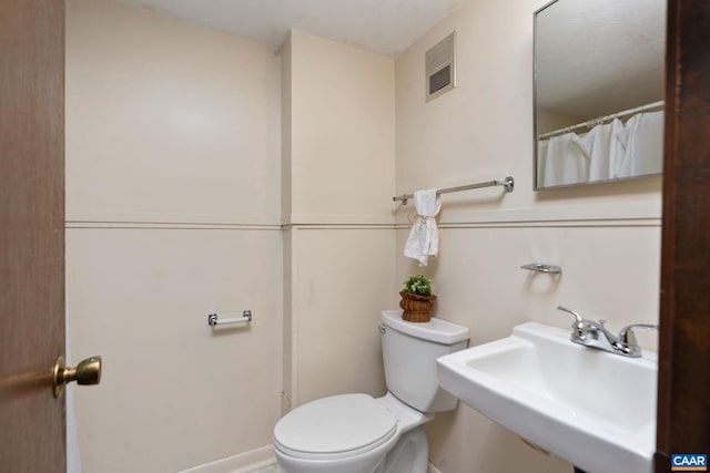 bathroom featuring sink and toilet