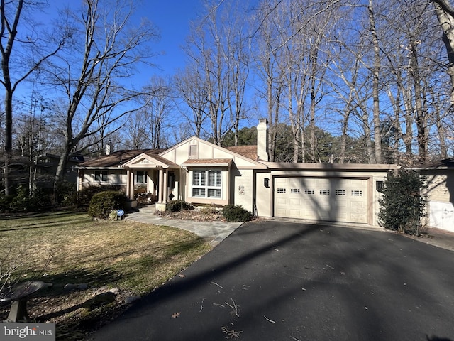 6508 Lakeview Dr, Falls Church, VA 22041 - view of front of home featuring a garage, a chimney, driveway, and stucco siding