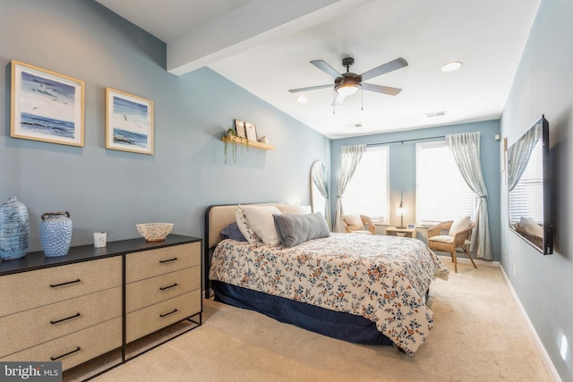 bedroom featuring ceiling fan, beam ceiling, and light carpet