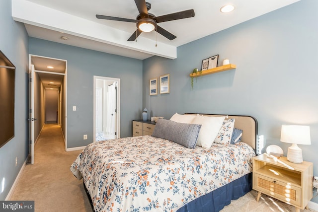 bedroom featuring beamed ceiling, light colored carpet, and ceiling fan