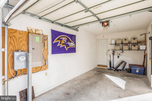 garage with a garage door opener and electric panel