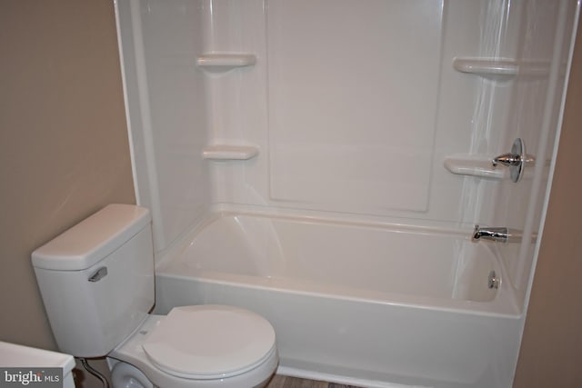 bathroom with washtub / shower combination and toilet