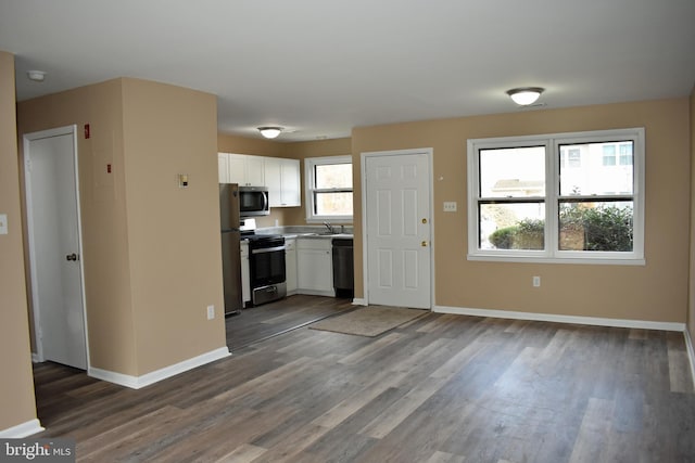 kitchen with sink, stainless steel appliances, dark hardwood / wood-style floors, and white cabinets