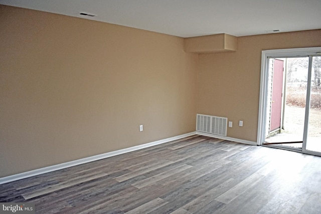 unfurnished room with wood-type flooring