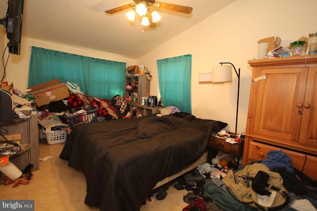 bedroom with ceiling fan, lofted ceiling, and light tile patterned floors