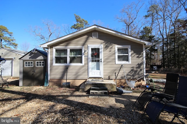 view of front of home with a garage and an outdoor structure