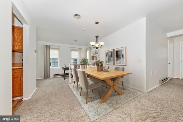 dining space with light carpet, a notable chandelier, and baseboard heating