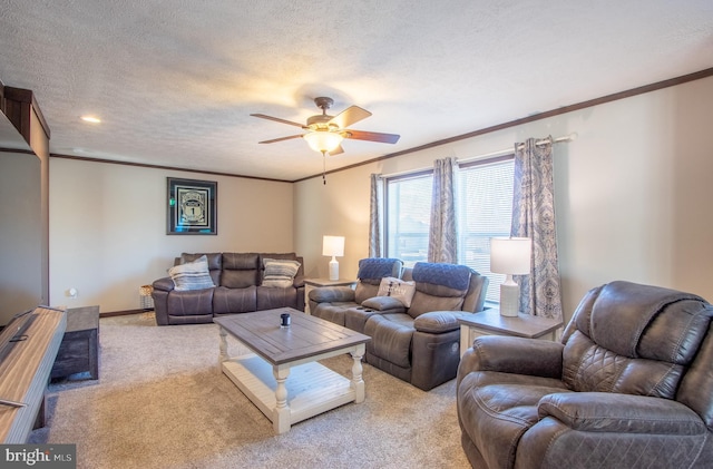 carpeted living room featuring ornamental molding, ceiling fan, and a textured ceiling