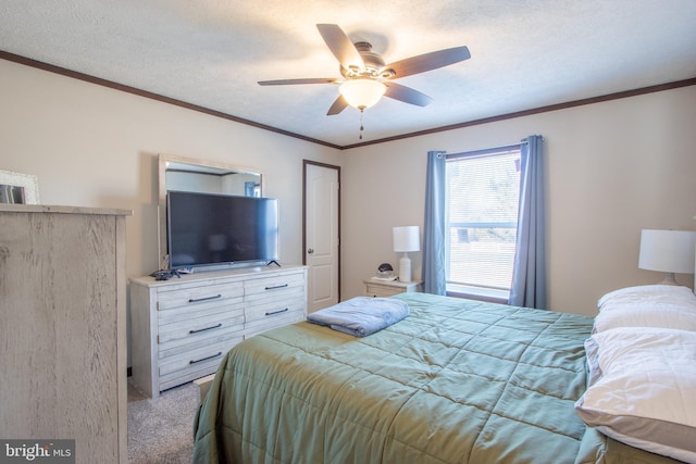 bedroom featuring ceiling fan, ornamental molding, light colored carpet, and a textured ceiling