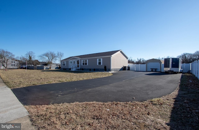 view of property exterior with an outbuilding, a yard, and a garage