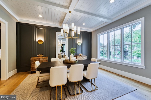 dining space with an inviting chandelier, recessed lighting, beam ceiling, light wood-style floors, and baseboards