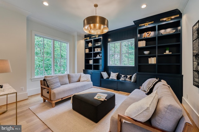 living area with built in features, baseboards, wood finished floors, recessed lighting, and ornamental molding