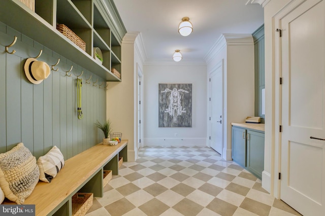 mudroom with light floors, baseboards, and ornamental molding