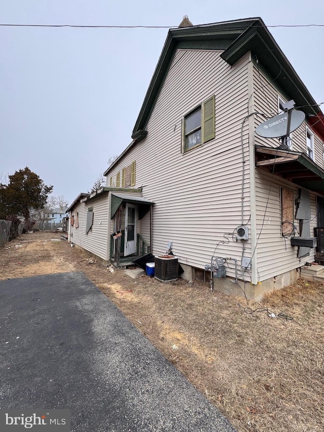 view of side of home with central air condition unit