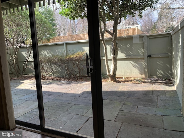 doorway to outside with stone tile floors