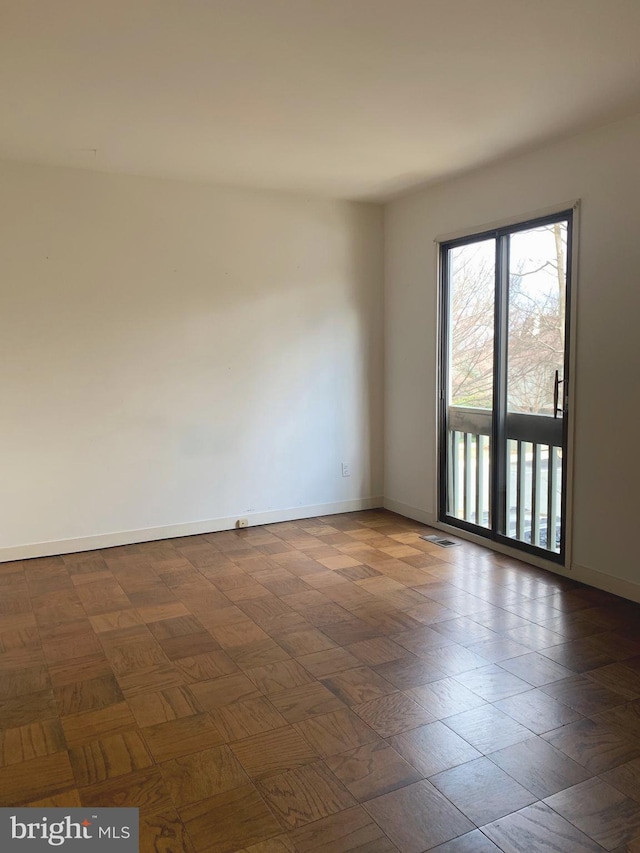 unfurnished room featuring visible vents and baseboards