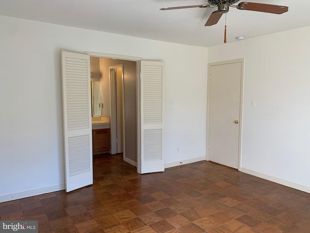 spare room featuring baseboards and a ceiling fan