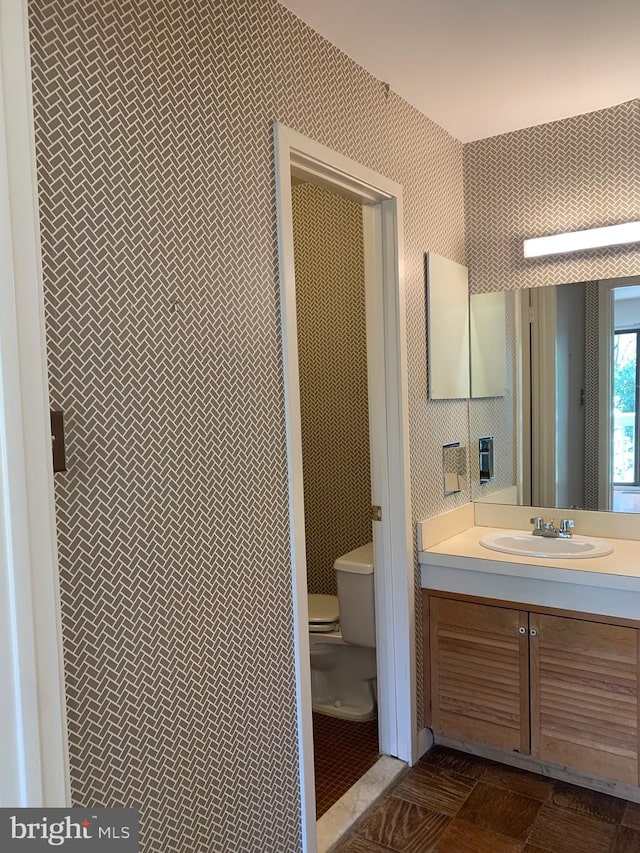 bathroom featuring vanity and toilet