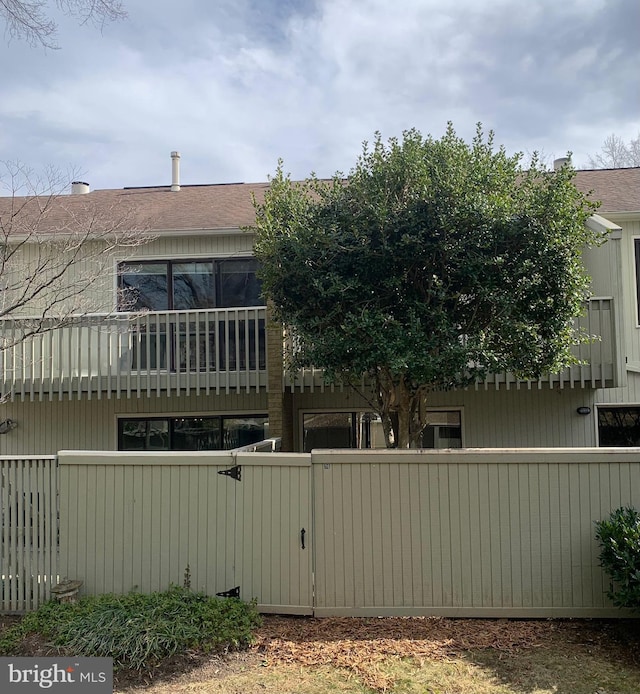 back of house featuring fence