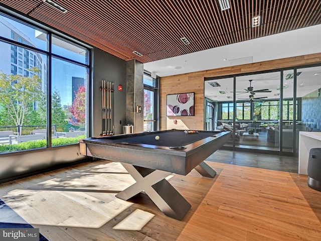 rec room featuring ceiling fan, pool table, wood walls, and wood finished floors