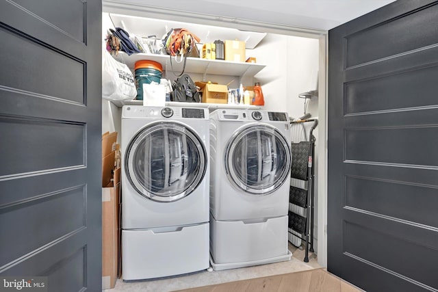 washroom featuring laundry area and separate washer and dryer