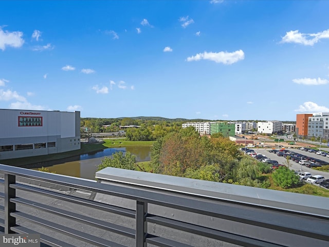 balcony featuring a view of city and a water view