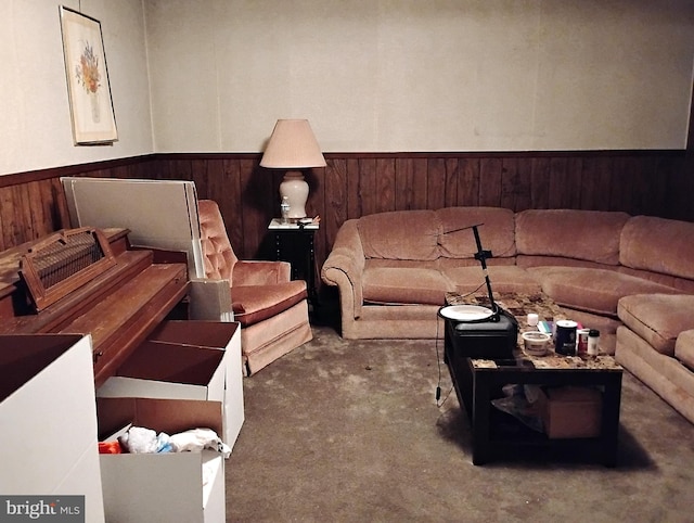 living room featuring carpet floors and wooden walls