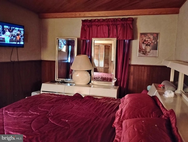 bedroom featuring wood ceiling and wood walls