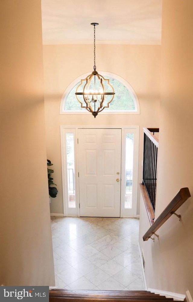 entryway with a chandelier and a high ceiling