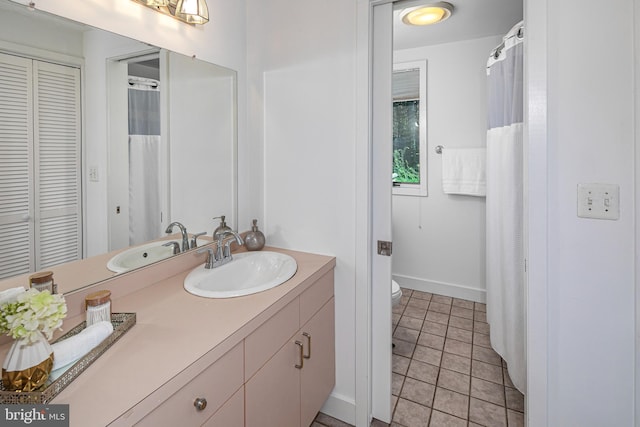74 Wilson Rd, Princeton, NJ 08540 - full bath featuring vanity, toilet, tile patterned floors, baseboards, and a closet