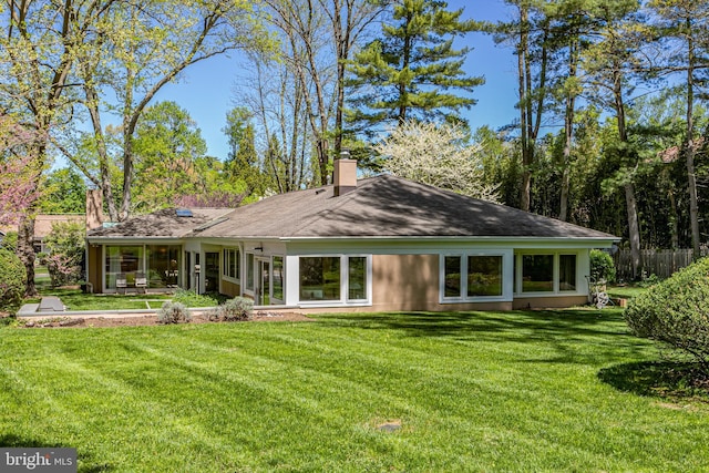 74 Wilson Rd, Princeton, NJ 08540 - back of house featuring a lawn, a chimney, and a sunroom