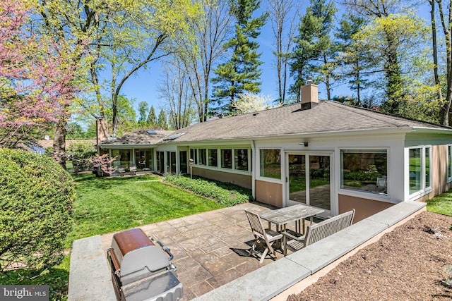 74 Wilson Rd, Princeton, NJ 08540 - rear view of property with roof with shingles, stucco siding, a chimney, a patio, and a yard