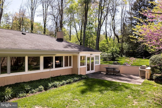 74 Wilson Rd, Princeton, NJ 08540 - back of property featuring a yard, a patio, a chimney, and a shingled roof