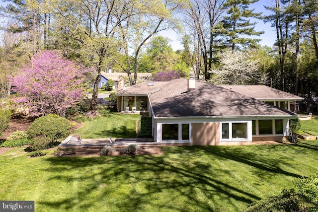 74 Wilson Rd, Princeton, NJ 08540 - rear view of house with a lawn, a chimney, and a shingled roof