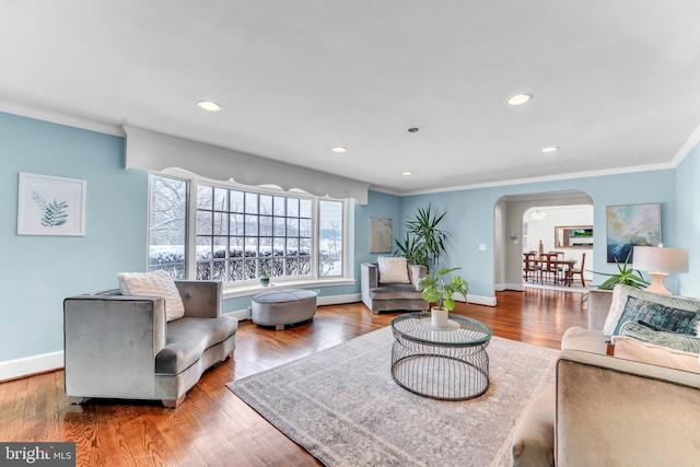 living room with hardwood / wood-style flooring and ornamental molding