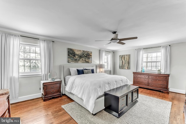 bedroom featuring ceiling fan, ornamental molding, and wood-type flooring